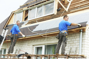 Two ASJ employees working on roofing job